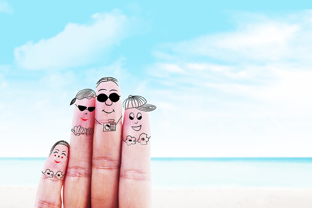 fingers with faces on it at the beach